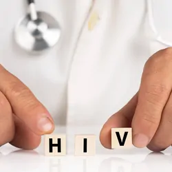 A clinician shows cubes with text HIVA clinician shows cubes with text HIV