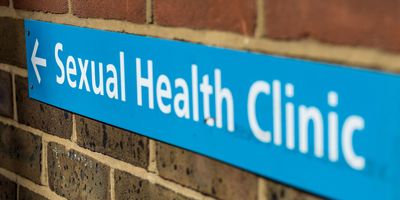 Sexual health clinic sign on a brick wall
