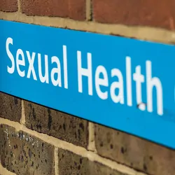 Sexual health clinic sign on a brick wall