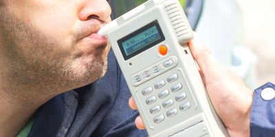 A man takes the breath analyzer test to check blood alcohol levels.
