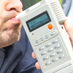 A man takes the breath analyzer test to check blood alcohol levels.