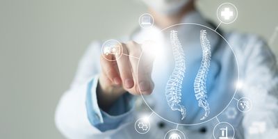 Clinician points to interactive, virtual vectors of the spinal cord and medicine-related icons.