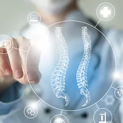 Clinician points to interactive, virtual vectors of the spinal cord and medicine-related icons.