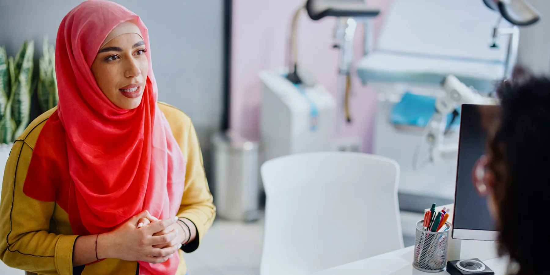 Innovations for Equitable Cervical Cancer Screening A woman in a headscarf sits across from a female doctor and talks about cervical cancer diagnosis.