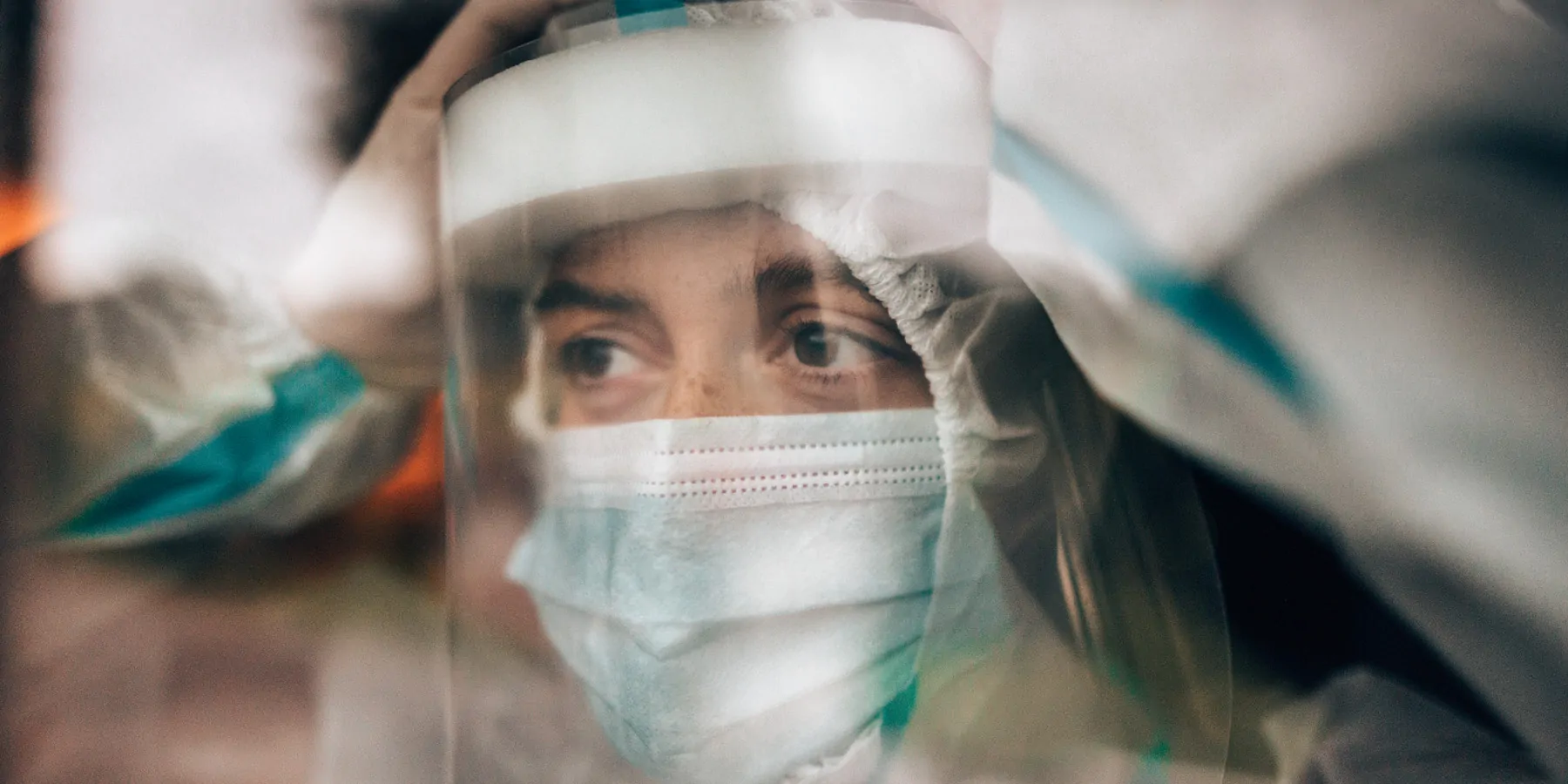 Photo of a medical laboratory technologist under pressure wearing personal protective equipment during the pandemic.
