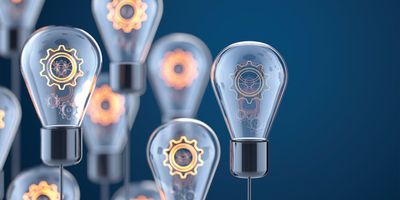 Illustration of lightbulbs with gears inside them representing innovation and new ideas in artificial intelligence and diagnostics.