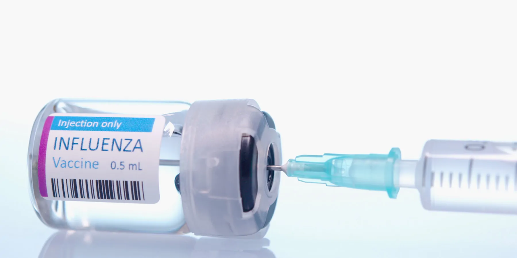 Phase 1 Trial of Universal Flu Vaccine Candidate Begins An influenza vaccine vial with a syringe ready to be loaded.