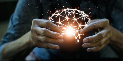 An elderly woman holds a virtual broken and damaged human brain by Alzheimer's disease on a dark background.