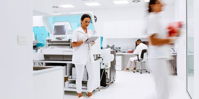 Scientists working in the laboratory surrounded by large equipment.