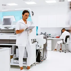 Scientists working in the laboratory surrounded by large equipment.