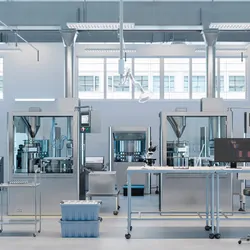 3D render of a laboratory and manufacturing facility with scientific monitors on desks.