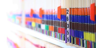 Photo of patient health records used for clinical trials stored a shelf.