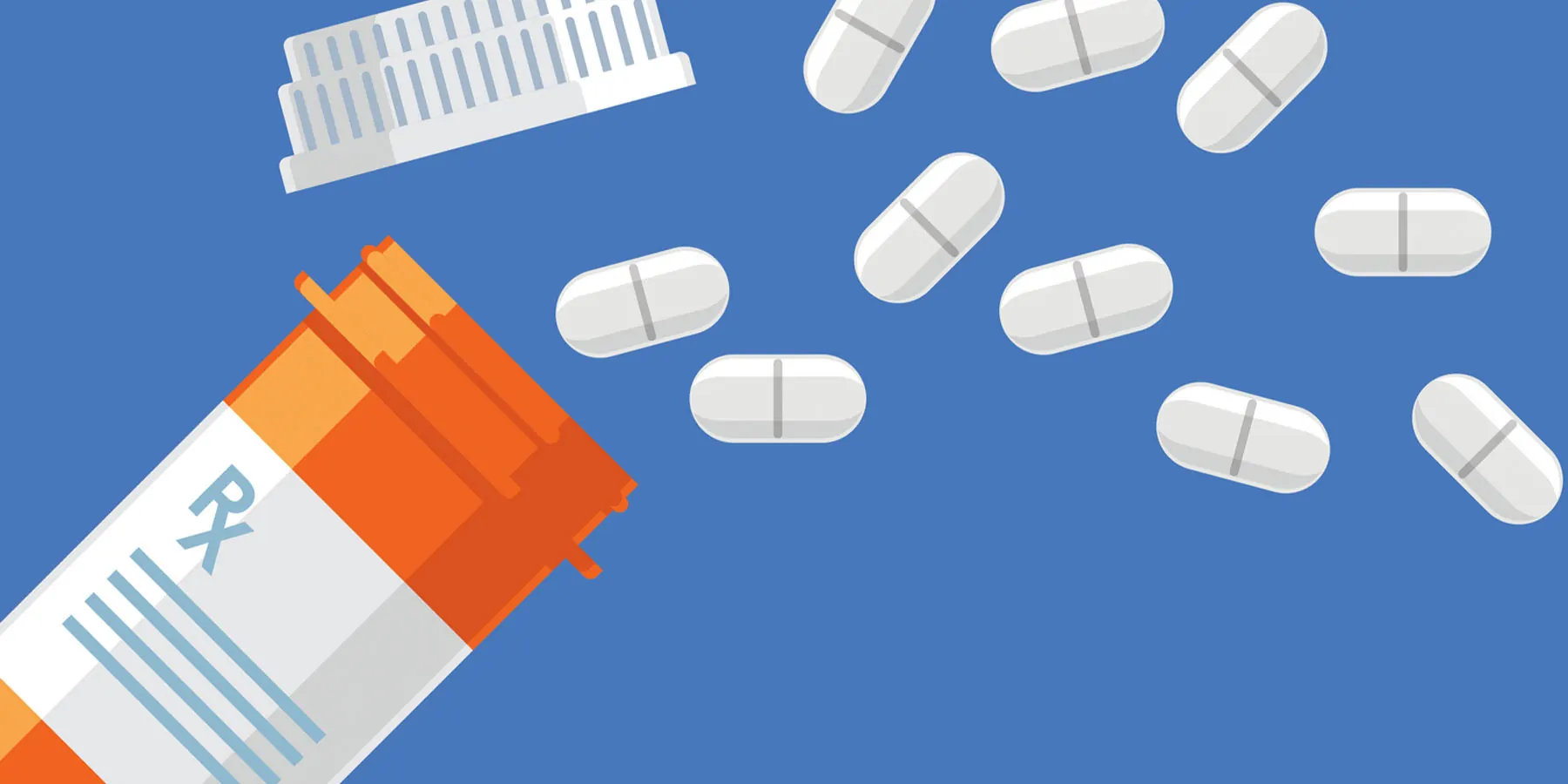 Pills fallen out of a prescription drug bottle on a blue background.