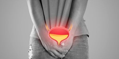 A person places both hands on the urinary bladder highlighted