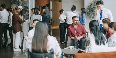 Photo of a room full of clinical laboratory professionals having conversations at a networking event.