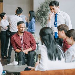 Photo of a room full of clinical laboratory professionals having conversations at a networking event.