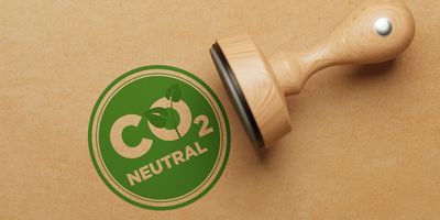 Illustration of a stamp that says CO2 neutral in green ink.