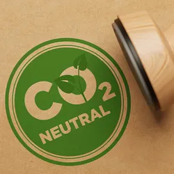 Illustration of a stamp that says CO2 neutral in green ink.