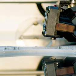 3D printer works on printing a microfluidic chip.