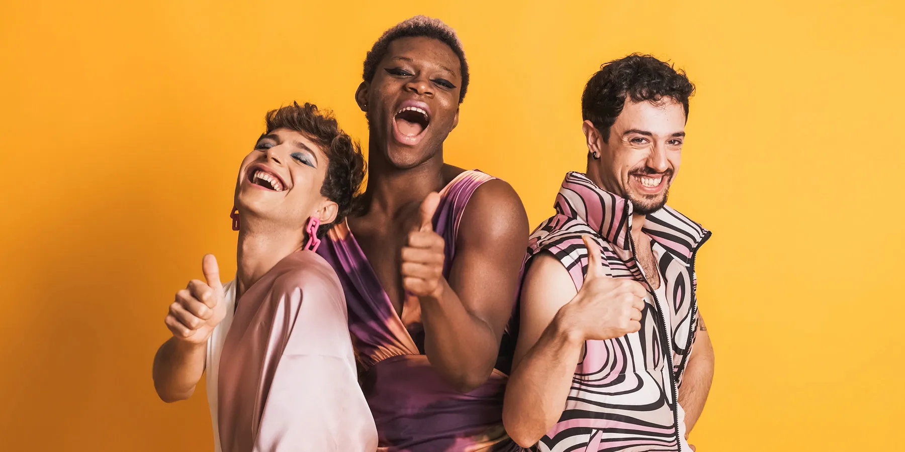 Multiracial LGBTQ people gesturing to be fine with a thumbs-up.