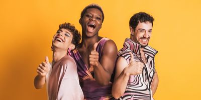 Multiracial LGBTQ people gesturing to be fine with a thumbs-up.