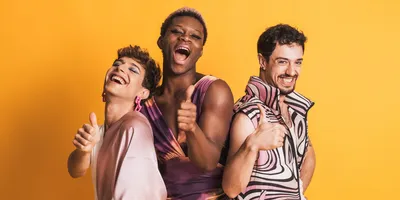 Multiracial LGBTQ people gesturing to be fine with a thumbs-up.