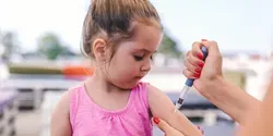 young girl getting an insulin shot