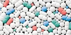 Lots of pills in mostly white, some red, blue, and green