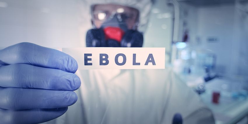 Laboratory technician holds a sign reading