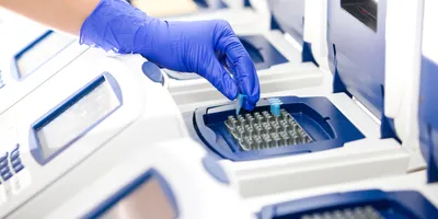 Technician performing syndromic PCR testing in laboratory