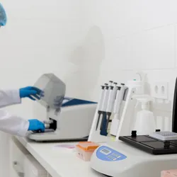 Laboratory technician analyzing urine samples for arsenic contamination