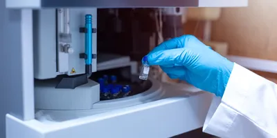 Close-up of lab technician handling a vial in hormone study