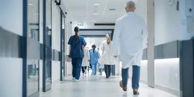 Medical professionals walking through a hospital corridor