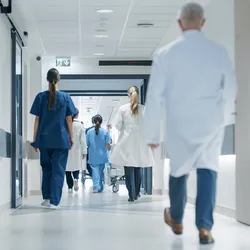 Medical professionals walking through a hospital corridor