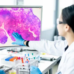 Clinical lab experts discussing IHC workflow optimization in a pathology lab.