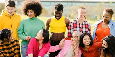 A cheerful multiracial group of happy friends in the park having fun.