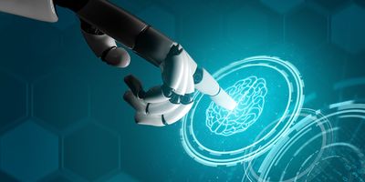 A robotic hand points to a virtual image of the human brain.