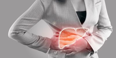 Illustration of a human liver on a woman's body as she holds the spot in pain with both hands.