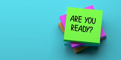 Photo of a sticky note that reads “Are you ready?” on a blue background.