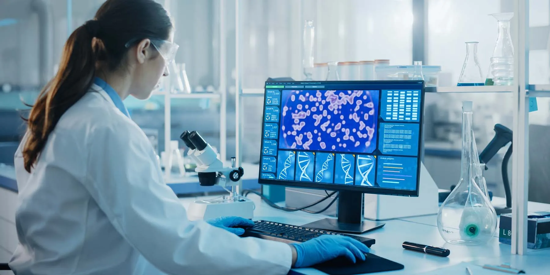 Clinical lab tech using a computer