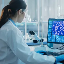 Clinical lab tech using a computer