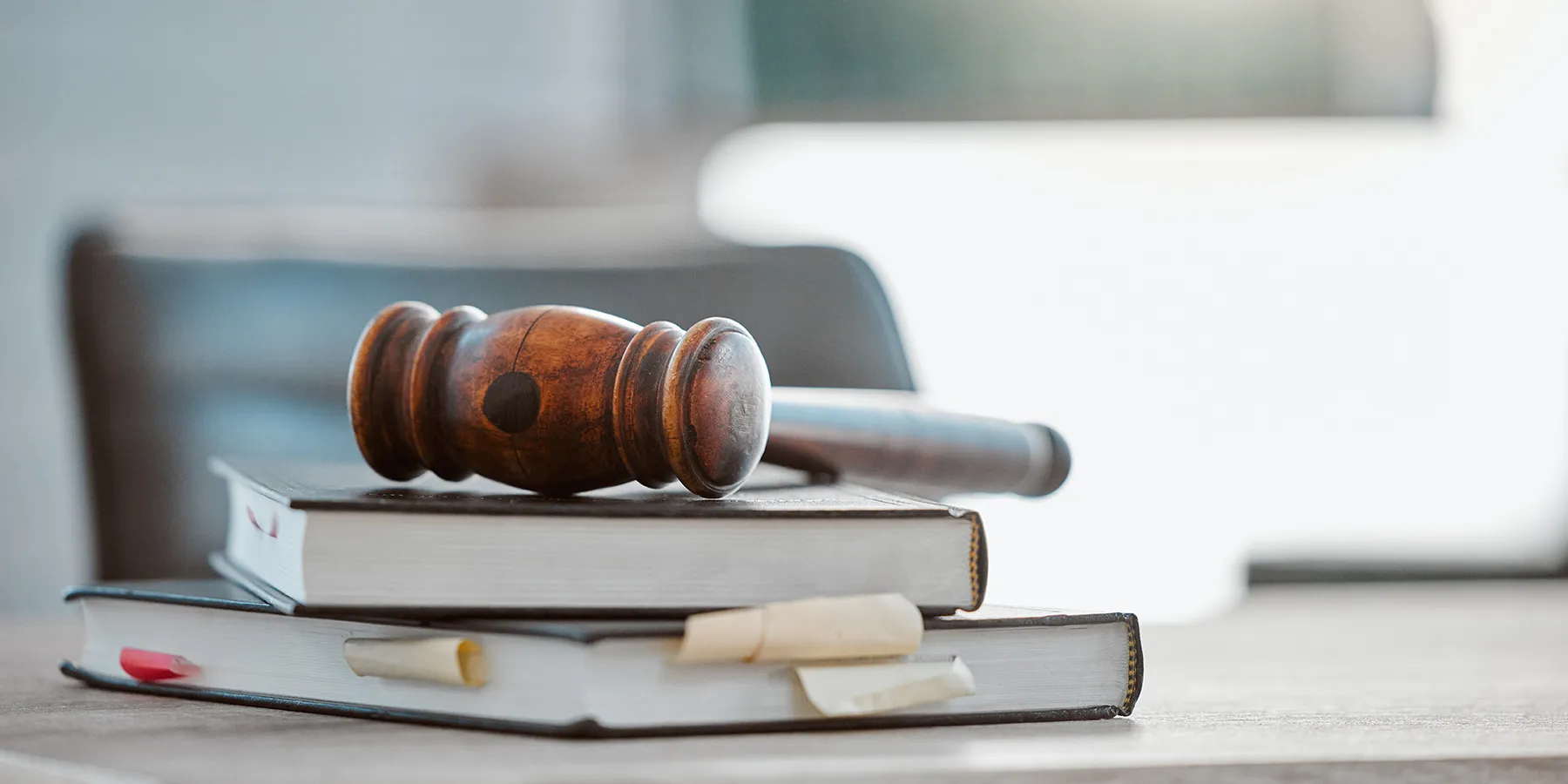 Photo of a gavel resting atop of a pile of law books in a US lawmaker’s office.