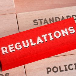 Photo of a red wood block that reads, Regulations, referring to the new regulation of lab-developed tests by the FDA.