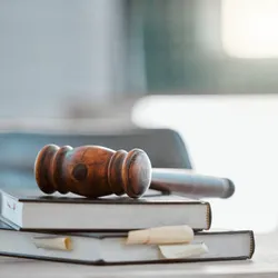 Judge’s gavel on legal reference books
