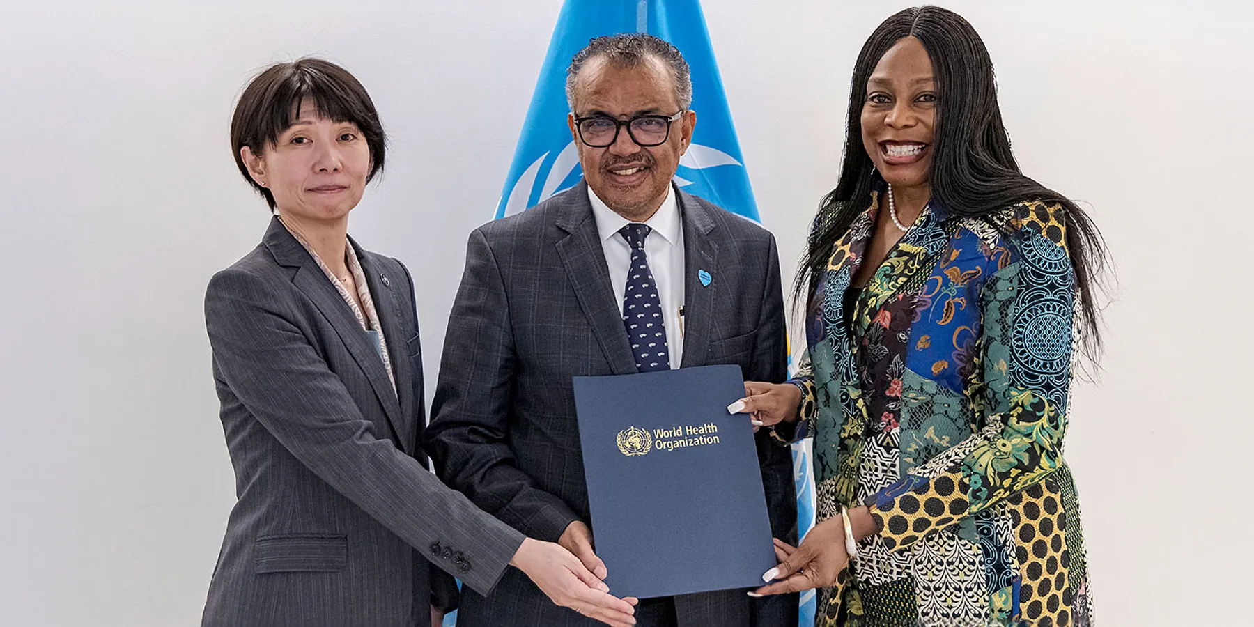 Three people holding a memorandum folder
