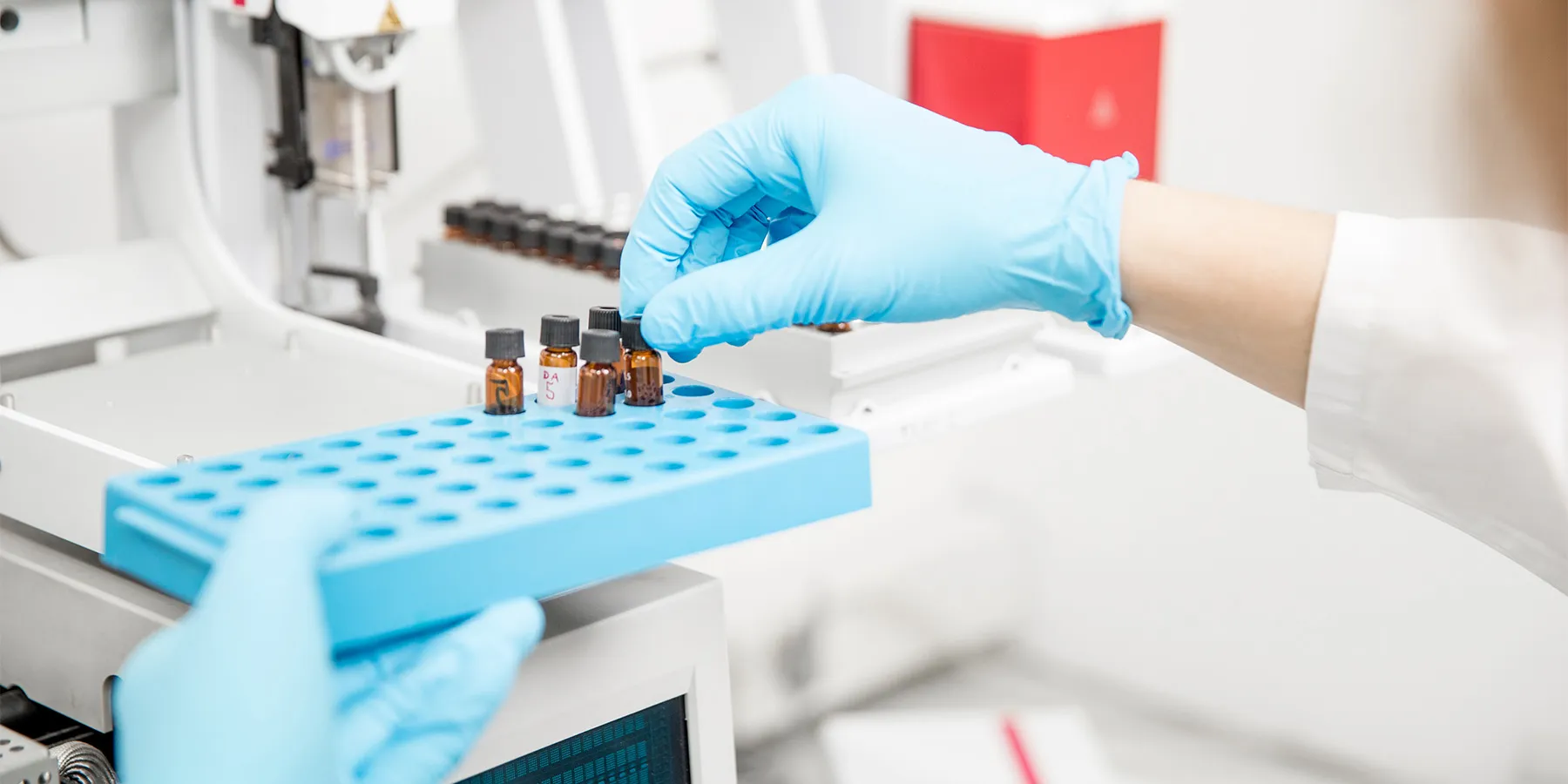 Photo of a clinical researcher wearing blue gloves loading samples for circulating microRNA analysis.