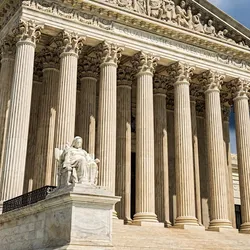 Photo taken of the front of the U.S. Supreme Court showing stairs and large columns.