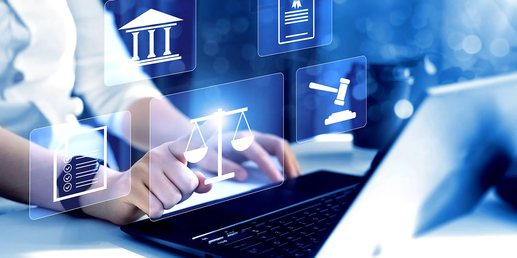 Photo of a clinical lab professional typing at a laptop keyboard with legal symbols overlayed on top of the photo.