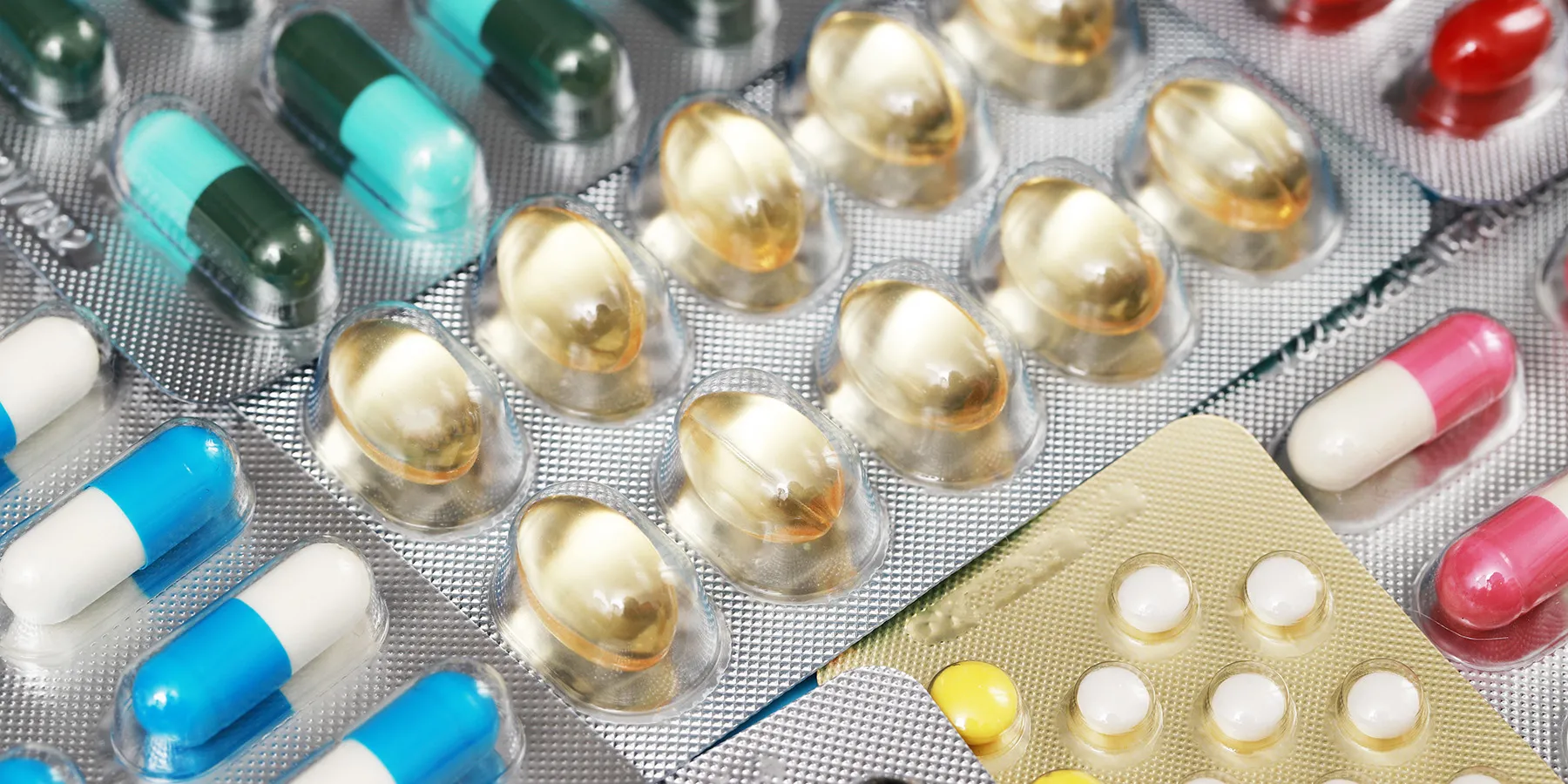 Photo of different medication tablets in therapeutics plastic blister packaging.