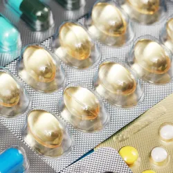 Photo of different medication tablets in therapeutics plastic blister packaging.